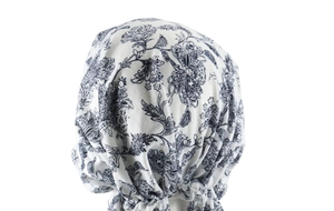 Detail of pre-tied headscarf back with blue floral paisley pattern on white fabric