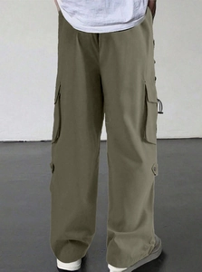 Detail view of olive green parachute cargo pants with side pockets and loose fit design