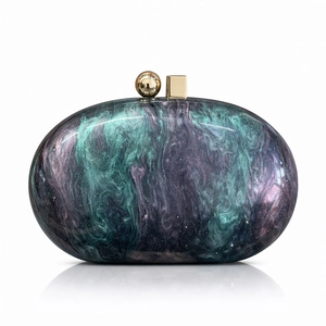 Detail of marble pattern acrylic evening clutch with gold geometric clasp closure