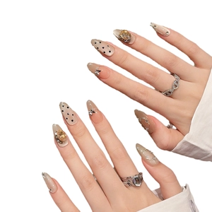 Handmade almond press-on nails with champagne glitter, 3D rhinestones and butterfly charms