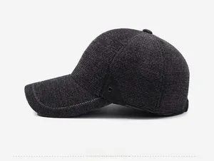 Detail view of charcoal gray thermal baseball cap showing textured fabric and vent hole