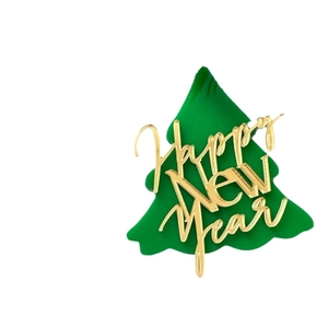 Green acrylic Christmas cake topper with golden Happy New Year text on white background