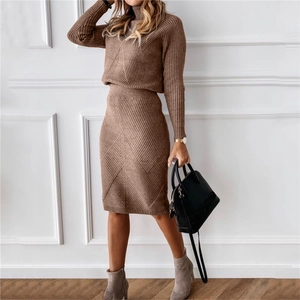 Detailed knit texture of a two-piece turtleneck sweater and skirt set in warm brown