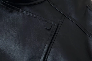 Macro shot of faux leather texture with precise stitching and a matte black snap button