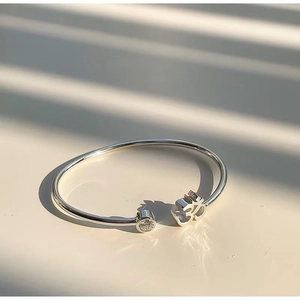 Elegant stainless steel open bangle with Om symbol and sparkling crystal inlay