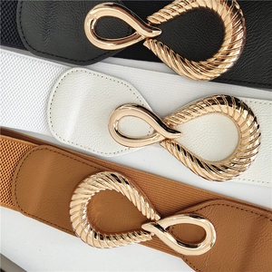 Three elastic waist belts in black white and brown with golden infinity twist buckles