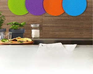 Detail of round honeycomb silicone placemats in green, purple, orange, and blue colors