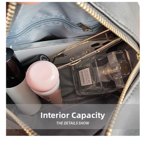 Detail view of the spacious inner compartment with essentials in a gray crossbody bag