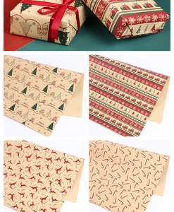 Detail of kraft Christmas wrapping paper with festive reindeer and tree patterns