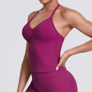 Women's high-impact racerback sports bra and leggings set in vibrant fuchsia for yoga