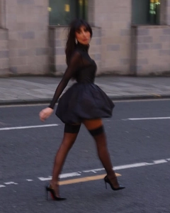 Vue de rue dynamique d'une robe noire élégante en tulle avec des manches transparentes