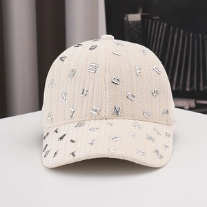 Cream corduroy baseball cap with silver metal letters and vertical textured finish