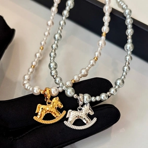 Elegant gold-plated rocking horse pearl necklace set in white and silver tones