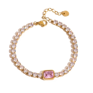 Detail of gold tennis bracelet featuring white zircons and a central pink rectangular stone