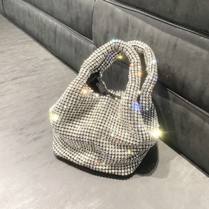 Close-up of sparkling silver rhinestone bucket bag showing detailed crystal craftsmanship