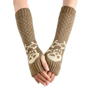 Detailed knit of brown arm warmers featuring beige skull pattern and white polka dots