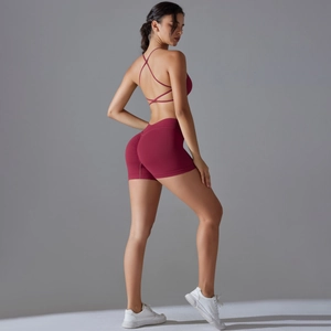 Macro shot of cross-back yoga bra and high-waisted seamless peach lifting shorts