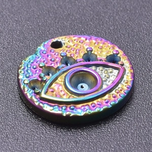 Macro shot of 18k gold plated stainless steel evil eye pendant with rainbow finish