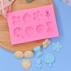 Pink silicone mold featuring cherry, peach, and flower patterns for DIY cake baking