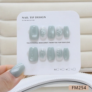Handmade cat eye press-on nails with silver bamboo design and pearl finish in grey green