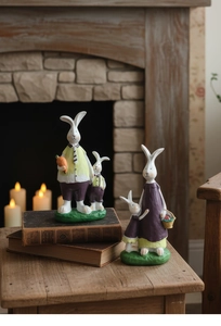 Detailed view of hand-painted resin rabbit family figurines with vintage wood-carved texture