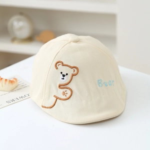 Detail of baby beige beret with brown bear embroidery and blue Bear lettering