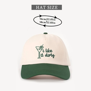 Close-up of 'i like it dirty' green embroidery on cream and forest green baseball cap