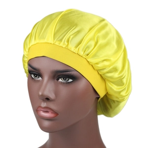 Detailed close-up of yellow silky satin bonnet featuring a wide elastic headband design