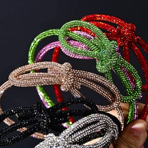 Close-up of sparkling rhinestone knotted headbands in multiple vibrant color variants