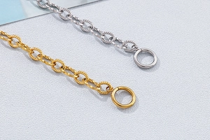 Close-up of gold and silver textured chain links with OT toggle clasps for tree of life bracelet