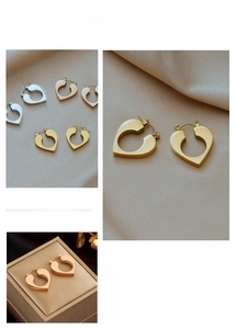 Macro detail of matte brushed hollow heart earrings in gold, silver and rose gold