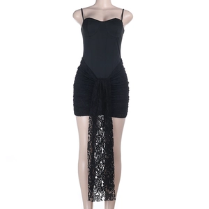 Detail of elegant black strapless dress featuring intricate lace patchwork on the hemline