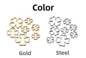 Detail view of 18k gold and steel hollow clover pendants in various sizes and finishes