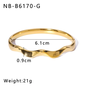 Detail shot of golden wave-textured stainless steel bangle showing 6.1cm inner diameter