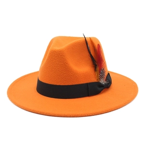Detailed close-up of orange wool felt fedora featuring black ribbon and colorful feathers