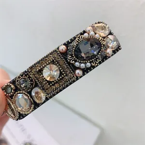 Macro detail of vintage rectangle hair clip with dark grey stone and pearls