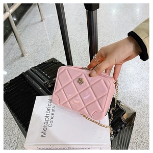 Close-up of pink quilted PVC jelly bag with gold chain strap and floral clasp detail
