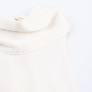 Détail d'un top en satin blanc avec col bénitier élégant et texture soyeuse de haute qualité