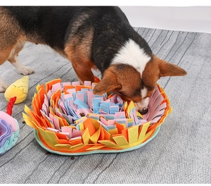 Golden Retriever dog playing with colorful round multi-layer pet snuffle mat training toy