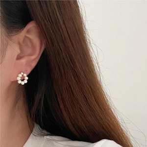 Elegant 925 silver pearl stud earrings in floral cluster design on a female model