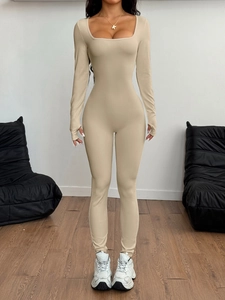 Detail shot of a beige long sleeve yoga jumpsuit with a square neckline and slim fit