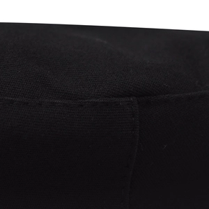 Close-up of black cotton military hat fabric with detailed stitching and woven texture