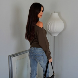 Detailed back view of dark olive off-shoulder knitted long sleeve top with blue jeans