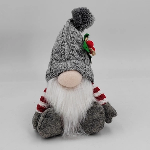 Detail of a Christmas gnome with gray knit hat, white beard and red striped sleeves