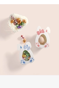 Detailed view of pink and blue bunny gift boxes with transparent windows and bow details