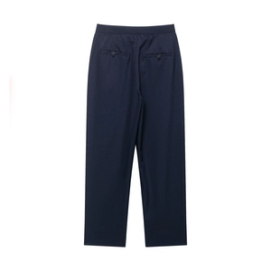 Detail view of navy blue suit trousers featuring two back pockets with button closures