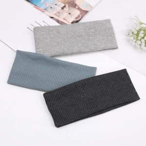 Set of three ribbed knitted elastic yoga headbands in grey, blue, and charcoal colors