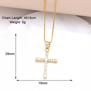 Detailed view of gold-plated cross pendant with clear cubic zirconia on a box chain