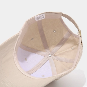 Detail view of cotton baseball cap interior showing white wash tag and neat inner seams