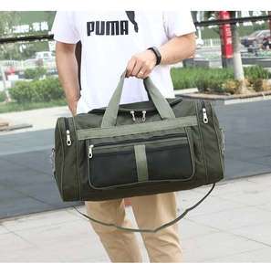 Close-up of army green travel bag with black mesh front pocket and adjustable shoulder strap